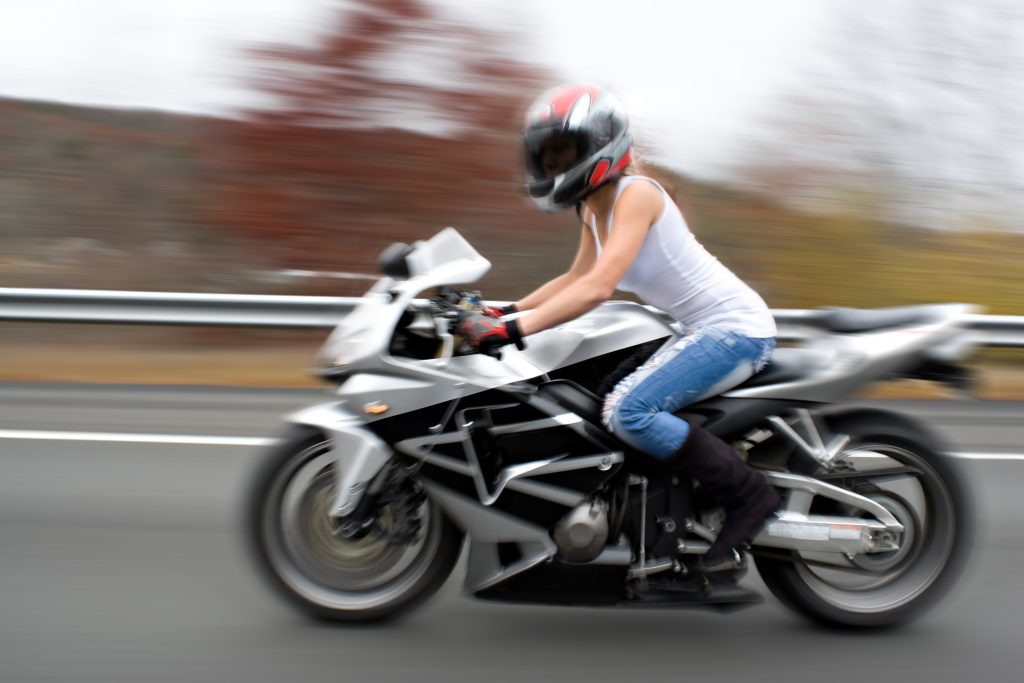 abstract blur of a pretty girl driving a motorcycle at highway speeds intentional motion blur St0ZXaOAHo