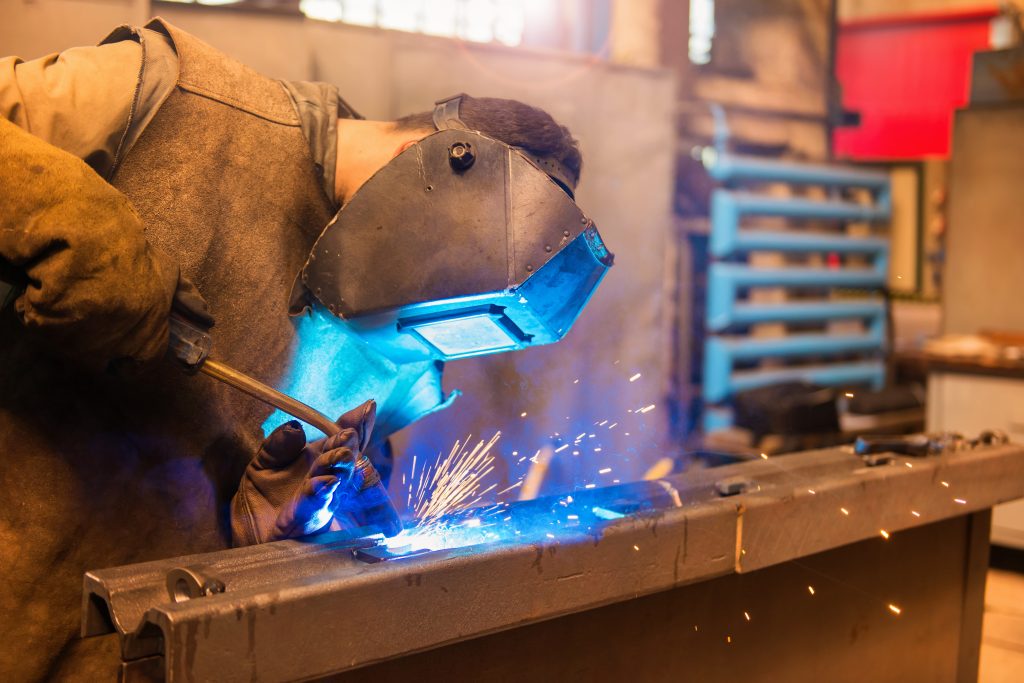 graphicstock young man with protective mask welding in a factory HRldhbcpZb